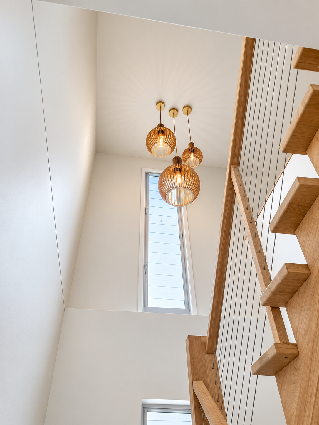 Stairwell pendant lighting in the completed home.